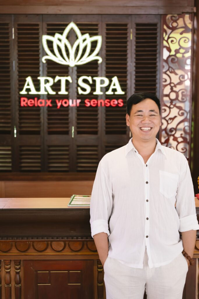 Tran Tuan Huy founder of Art Spa Hoi An standing at spa reception in Hoi An Vietnam